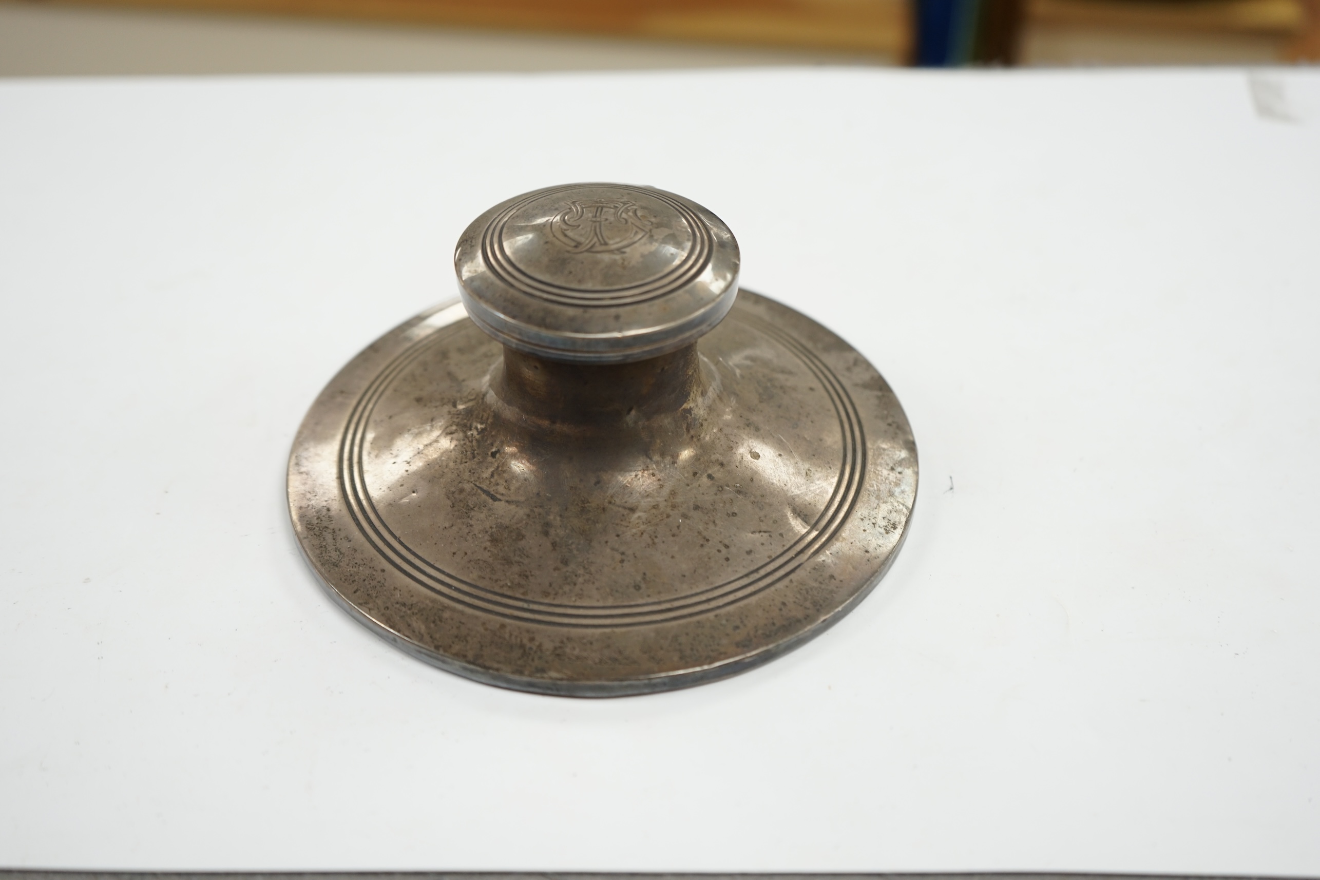 A George V silver mounted capstan inkwell, Birmingham, 1910, base diameter 15.2cm. Condition - poor to fair